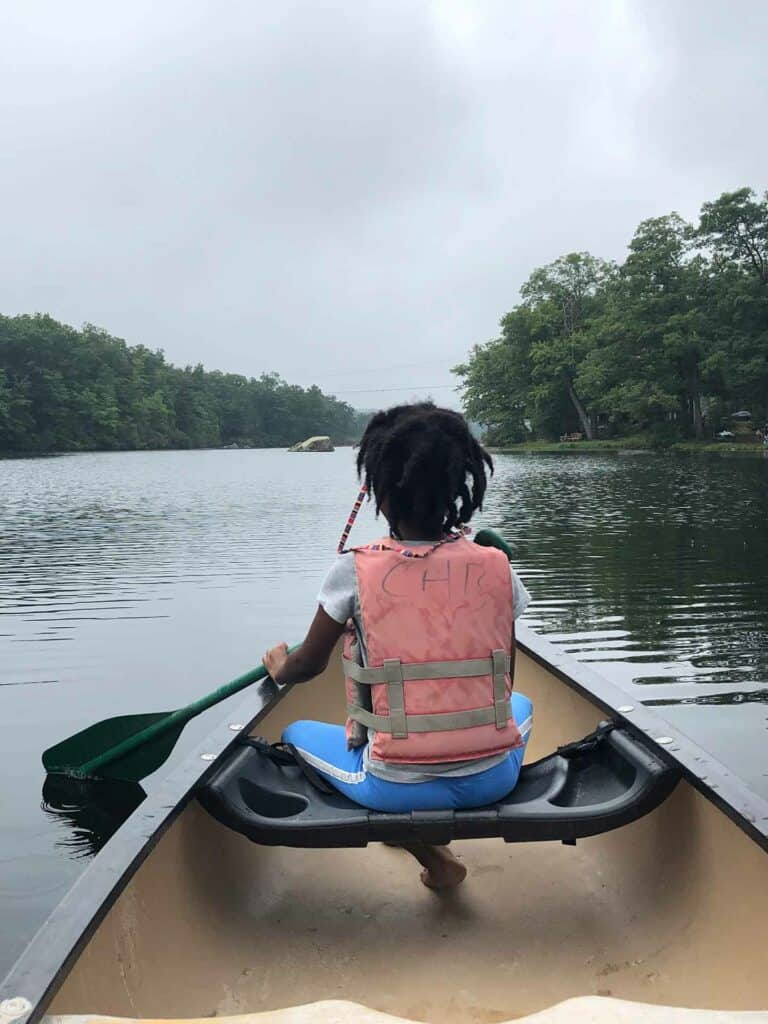 usa-camp-female-camper-canoe-lake
